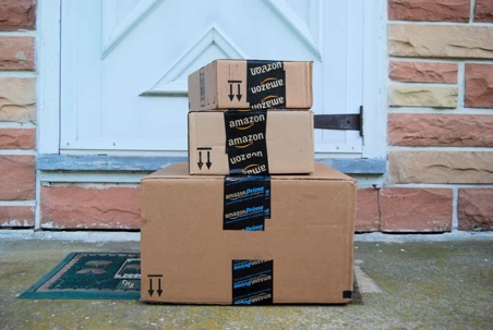 Amazon boxes stacked on a doorstep